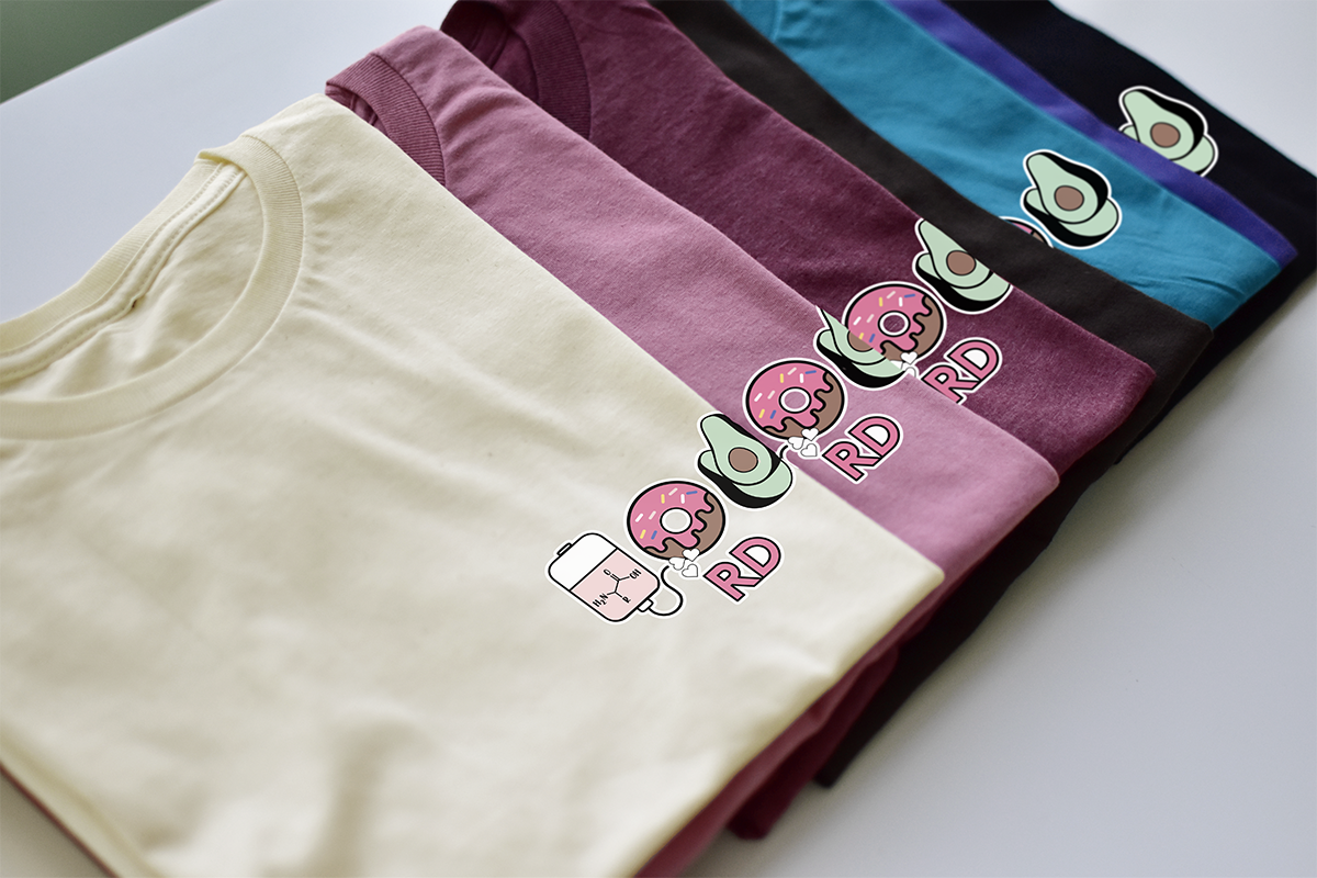 Stack of folded t-shirts with colorful graphics on a white surface