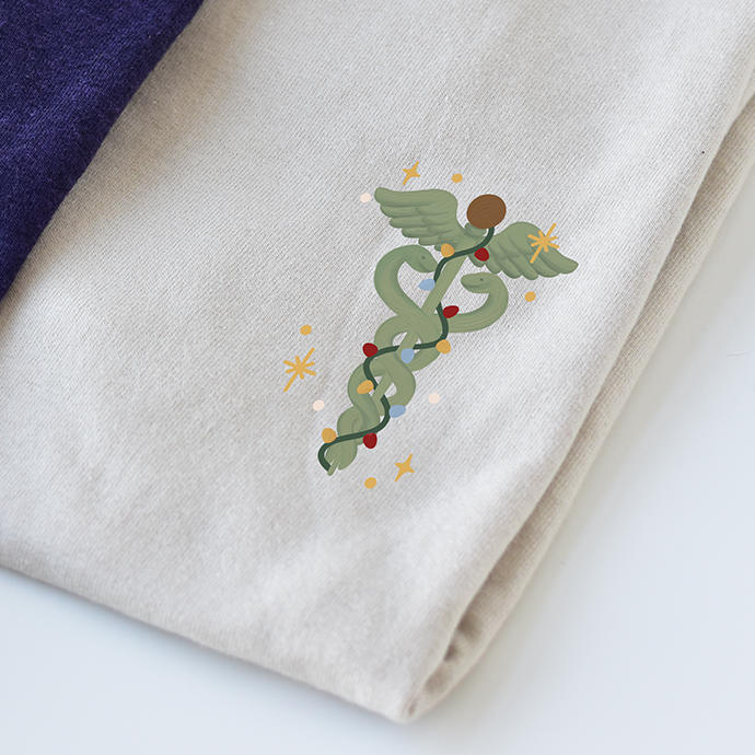 Caduceus design on cream shirt