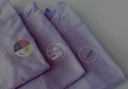 purple shirts with indigenous fundraiser logos 
